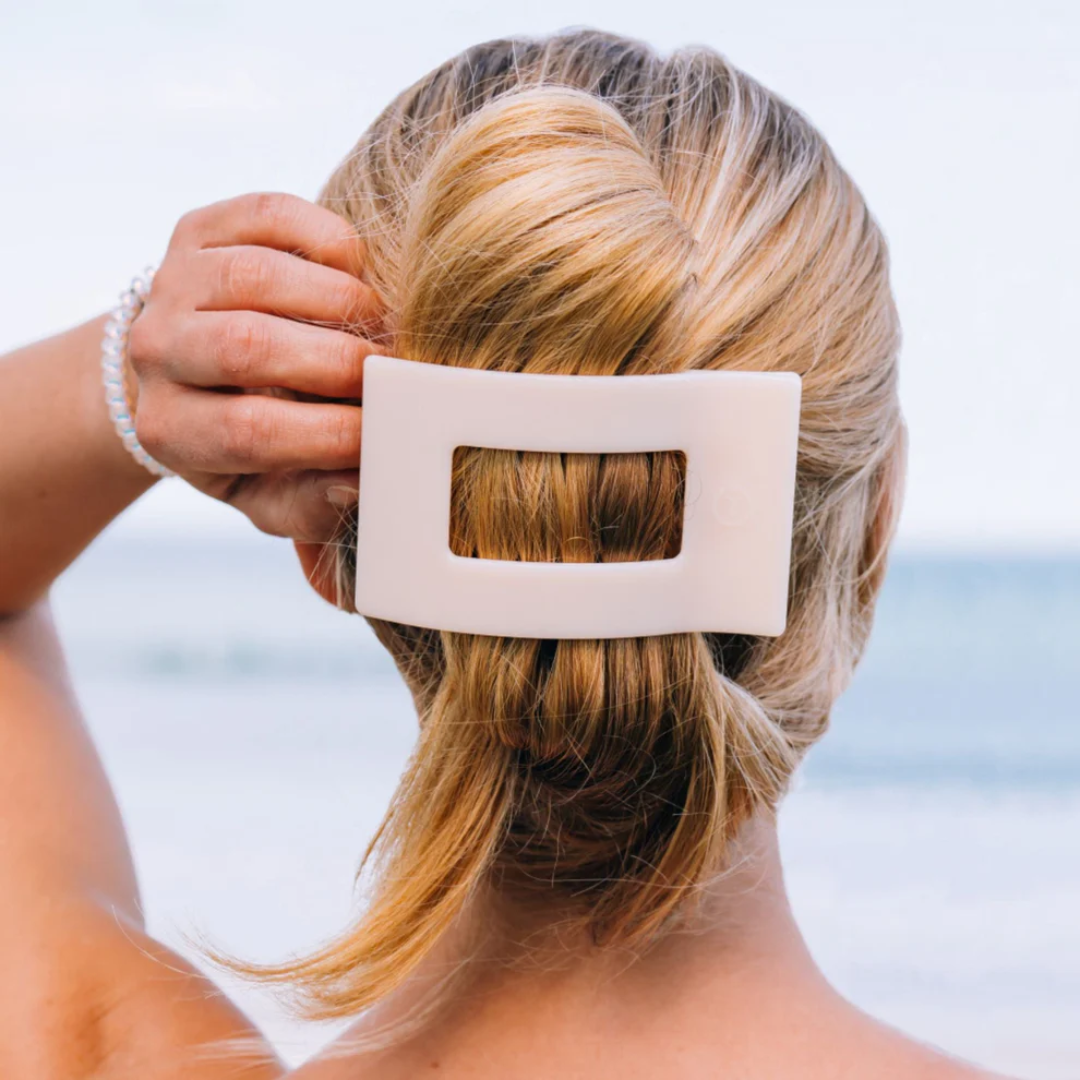 square hair clip in models hair against neutral background