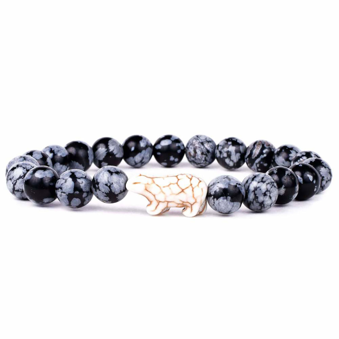 Black and gray beaded bracelet with a gold elephant charm on a white background
