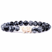 Black and gray beaded bracelet with a gold elephant charm on a white background