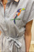 striped dress with a colorful parrot embroidery on a neutral background