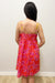 Woman wearing pink dress with dark pink patterns