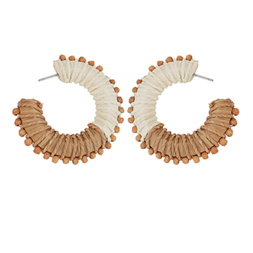 Pair of hoop earrings with beige and white design on a white background