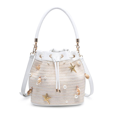 White woven handbag with starfish and shell decorations on a white background