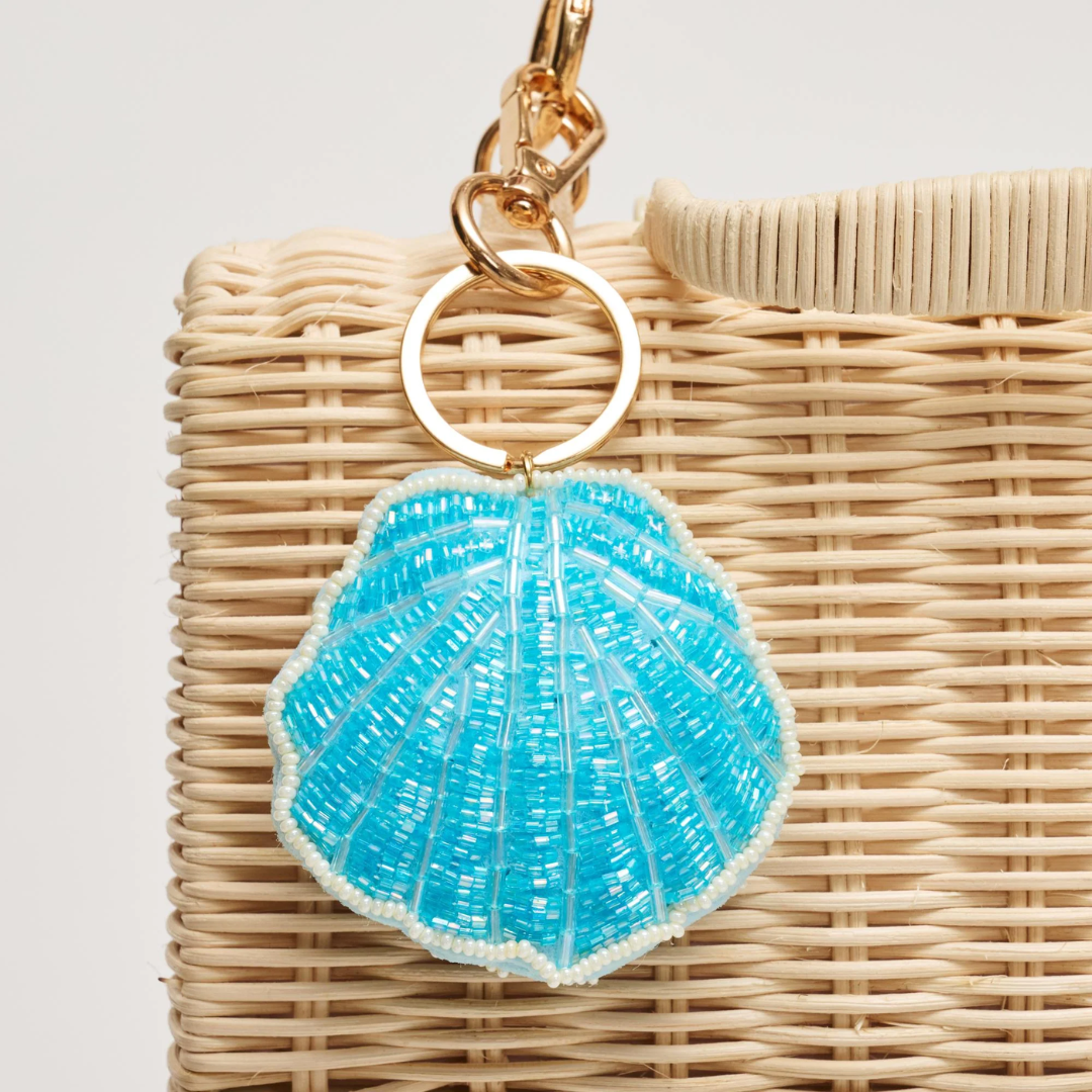 Blue shell keychain on a wicker bag with a light background