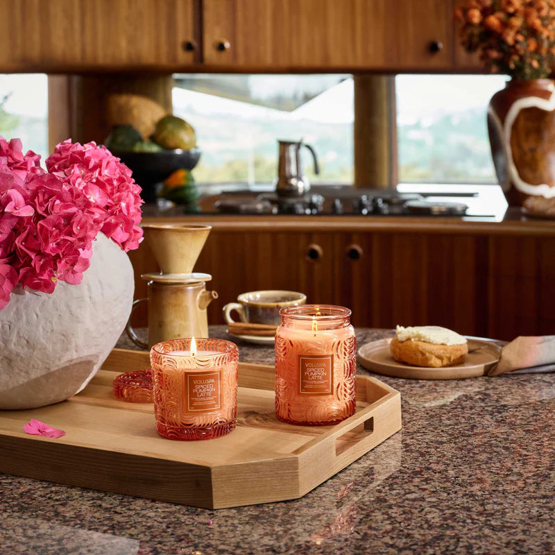 Candles on a wooden tray with a kitchen background