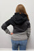Woman wearing Wanakome Selene Hoodie In Black Carbon Mix on a plain white background.