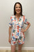 Woman wearing a colorful Sea-themed pajamas against a plain background