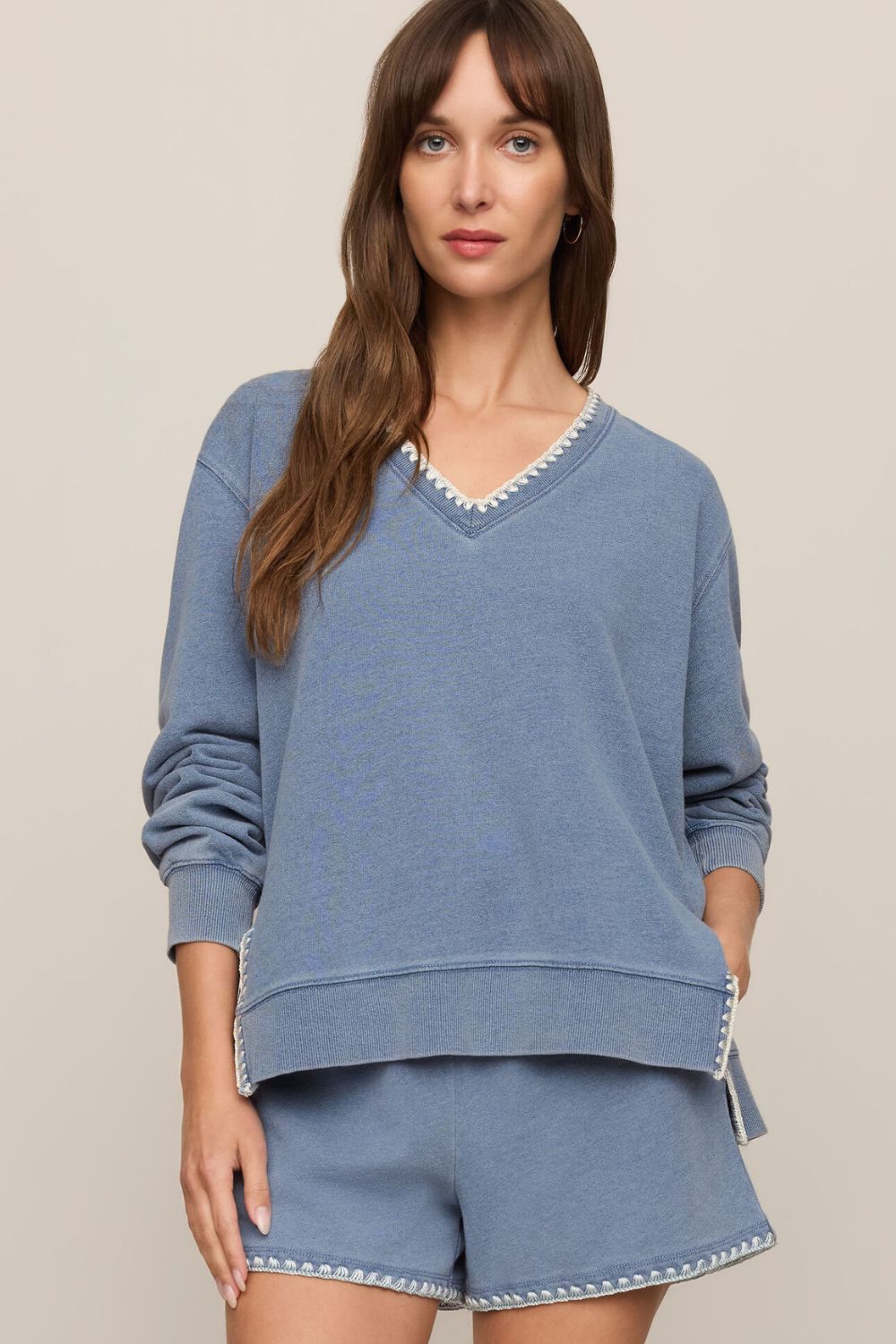 woman wearing a blue sweater on a white background