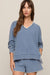 woman wearing a blue sweater on a white background