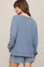 woman wearing a blue sweater on a white background