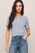 woman wearing blue sweater on a white background