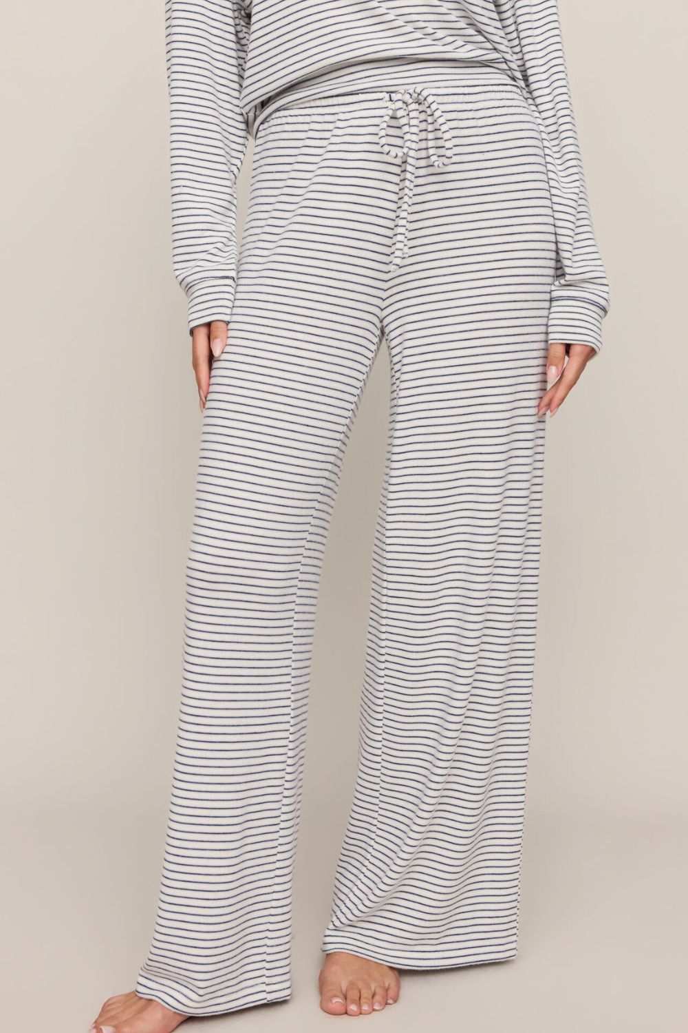 woman wearing striped pants on a white background