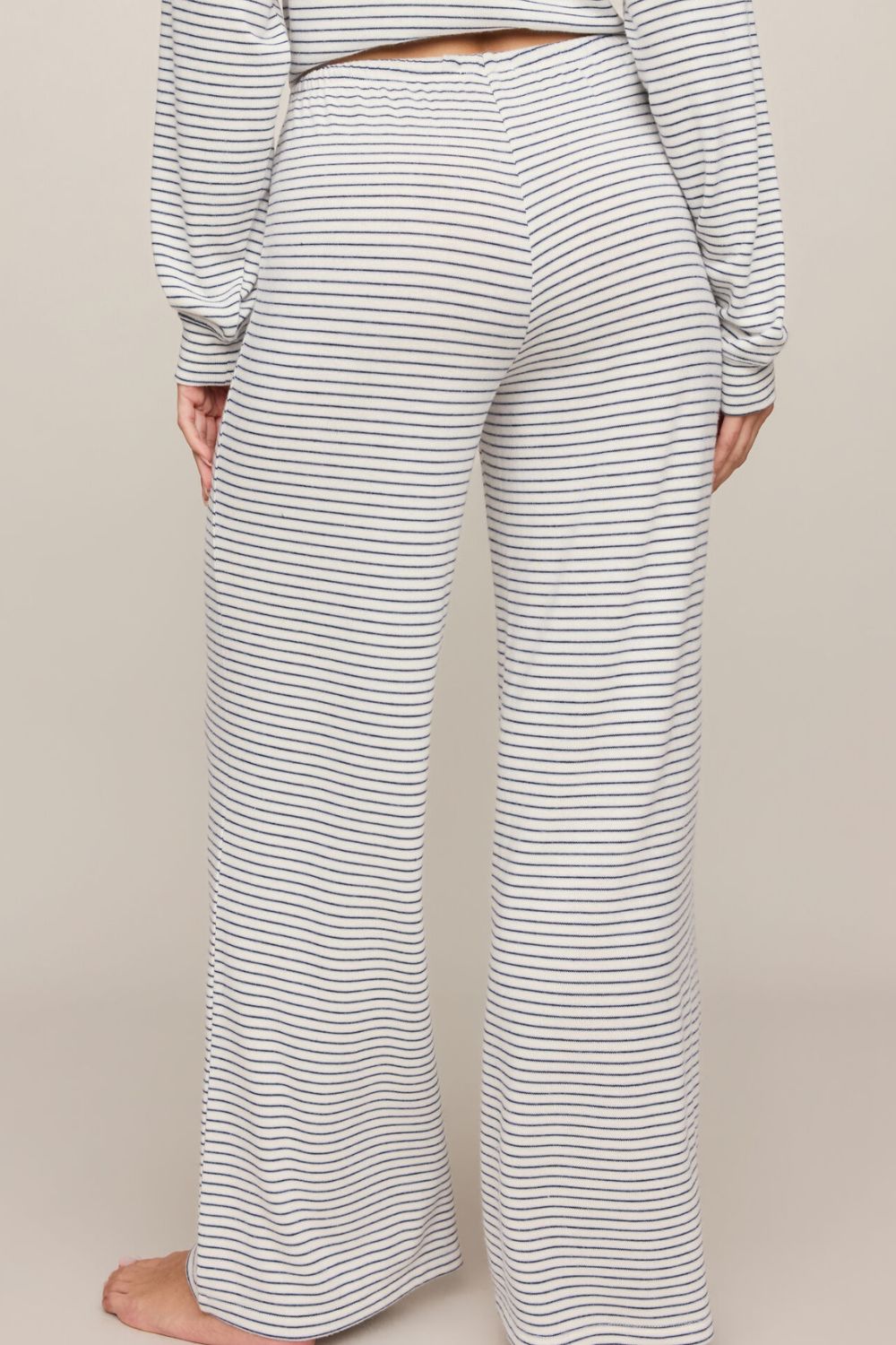 woman wearing striped pants on a white background