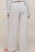woman wearing striped pants on a white background