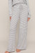 woman wearing striped pants on a white background
