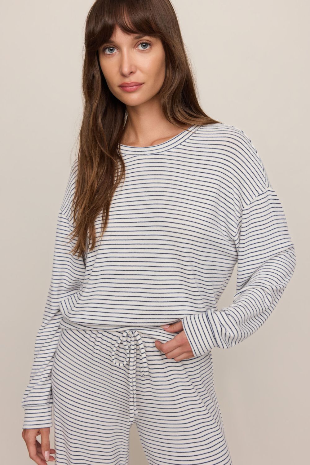 woman wearing a striped sweater on a white background