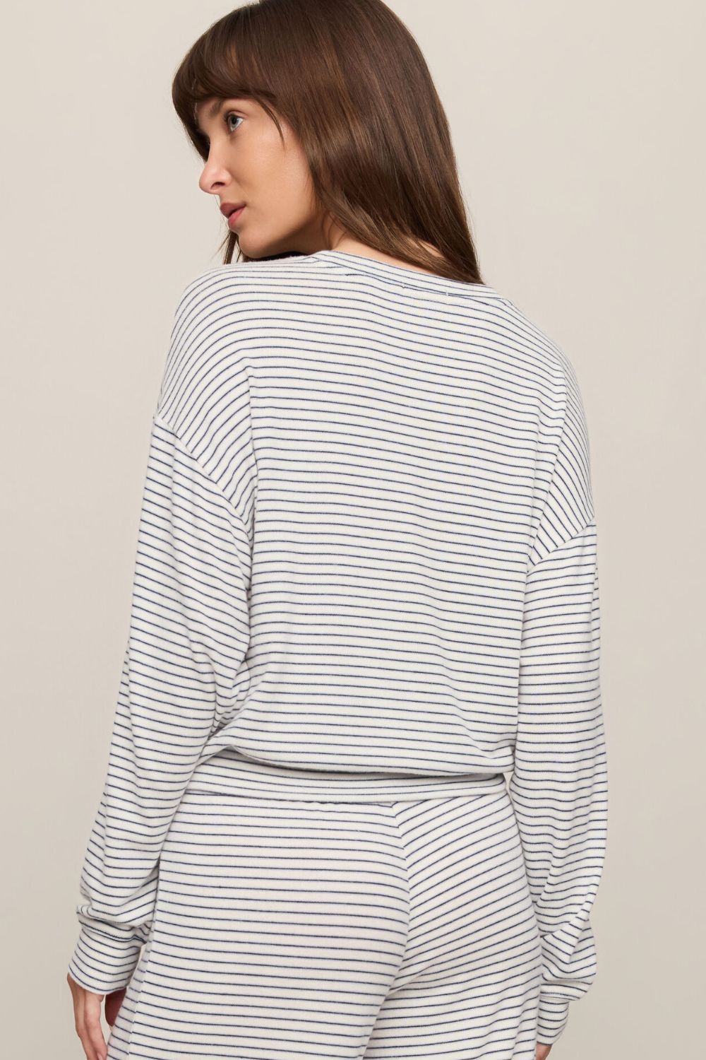 woman wearing a striped sweater on a white background