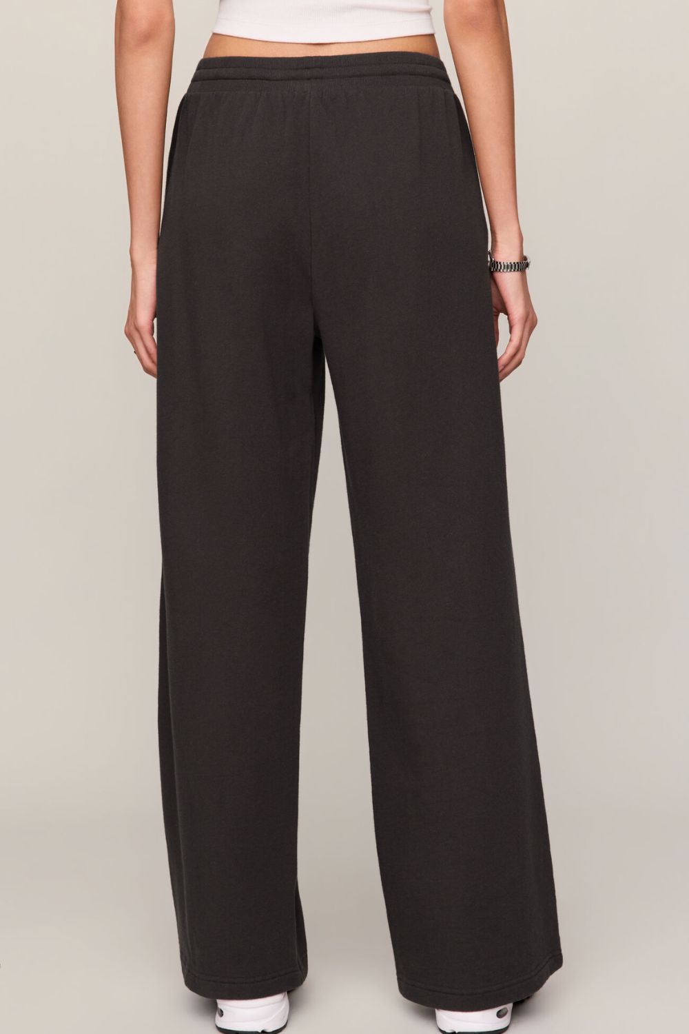 woman wearing black pants on a white background