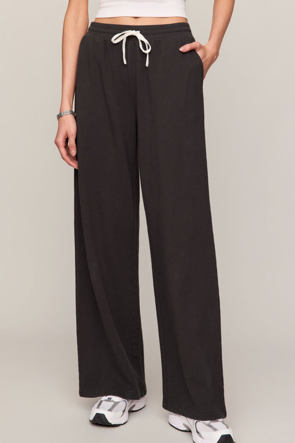 woman wearing black pants on a white background