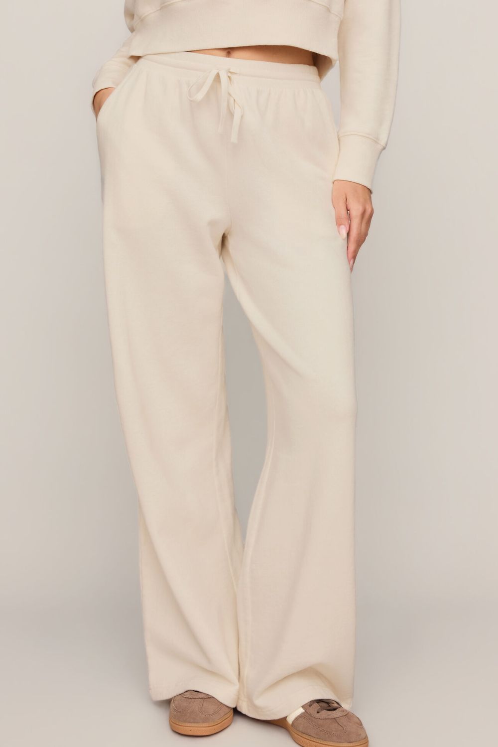 woman wearing white pants on a white background