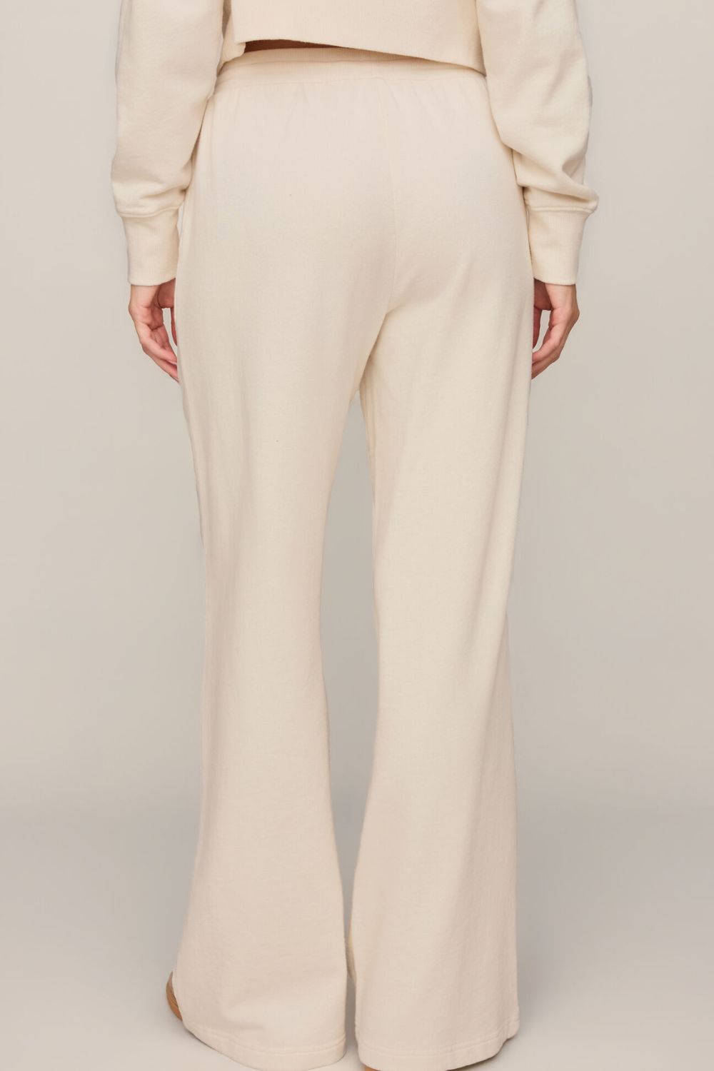 woman wearing white pants on a white background
