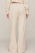 woman wearing white pants on a white background