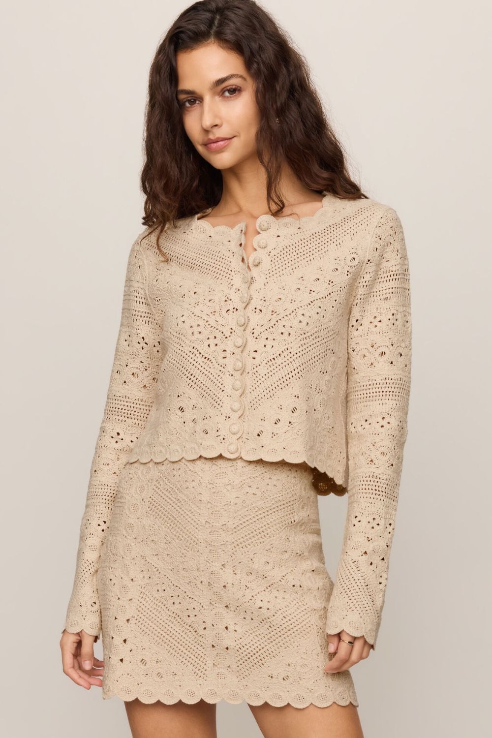 woman wearing tan textured set with a white background