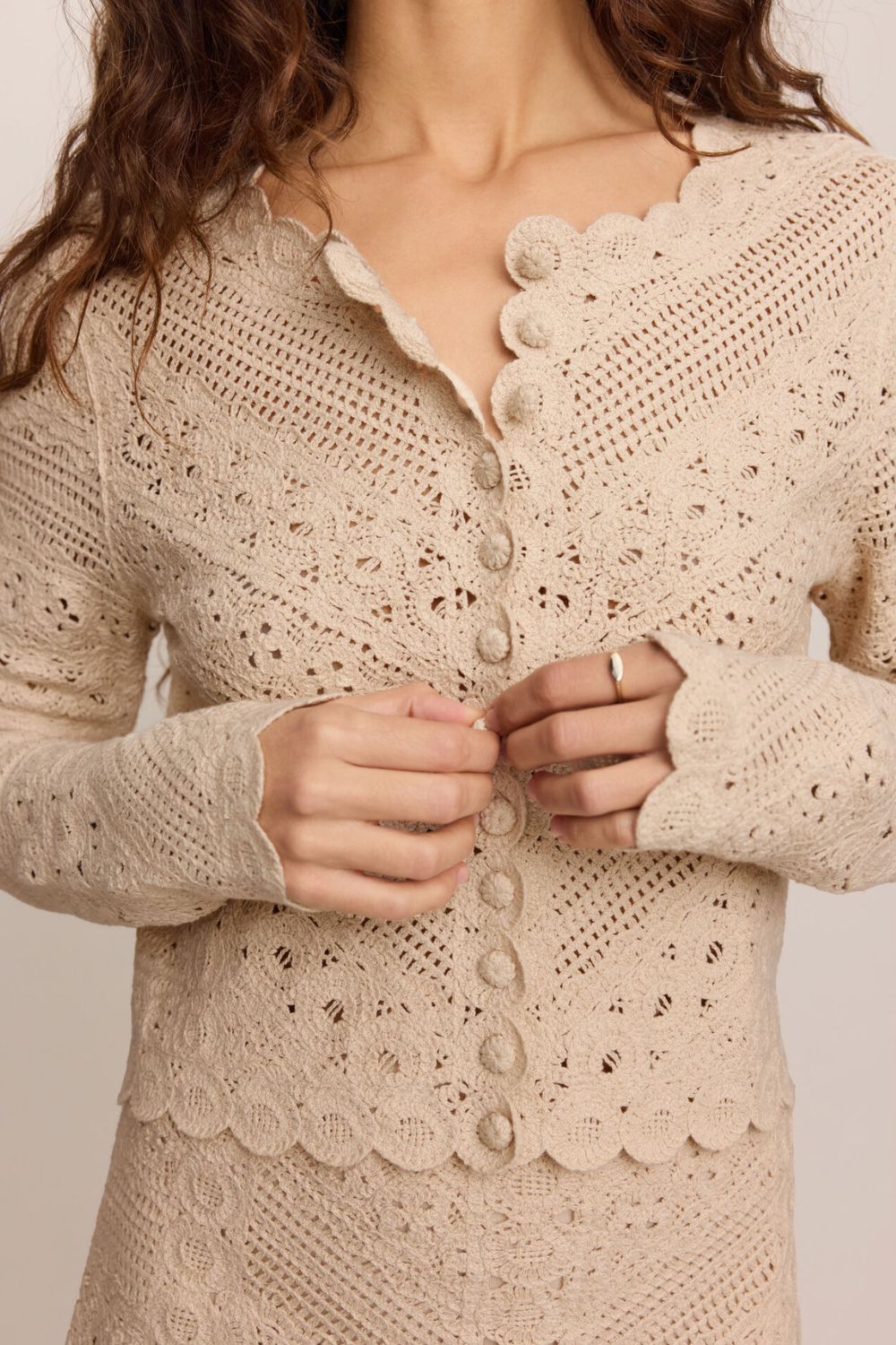 woman wearing tan textured set with a white background