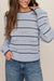 woman wearing striped blue sweater on a white background