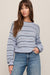 woman wearing striped blue sweater on a white background