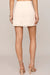 woman wearing embroidered skirt with a white background