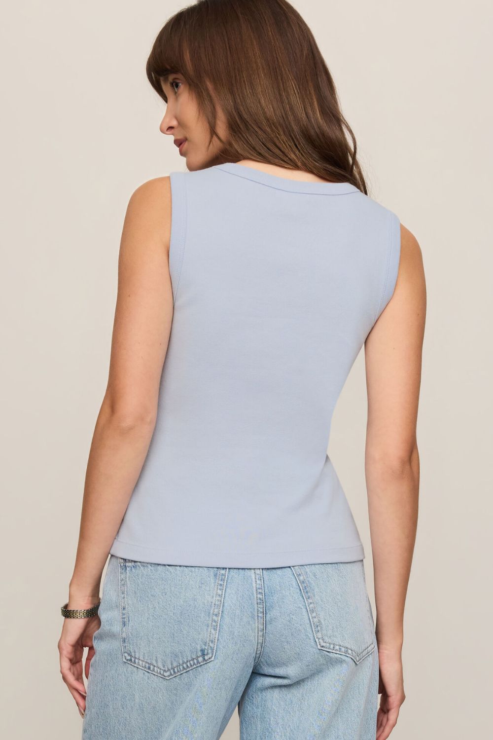 woman wearing a blue tank top on a white background