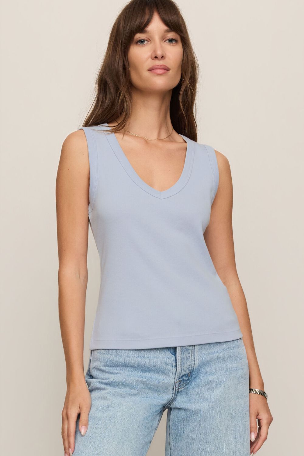 woman wearing a blue tank top on a white background