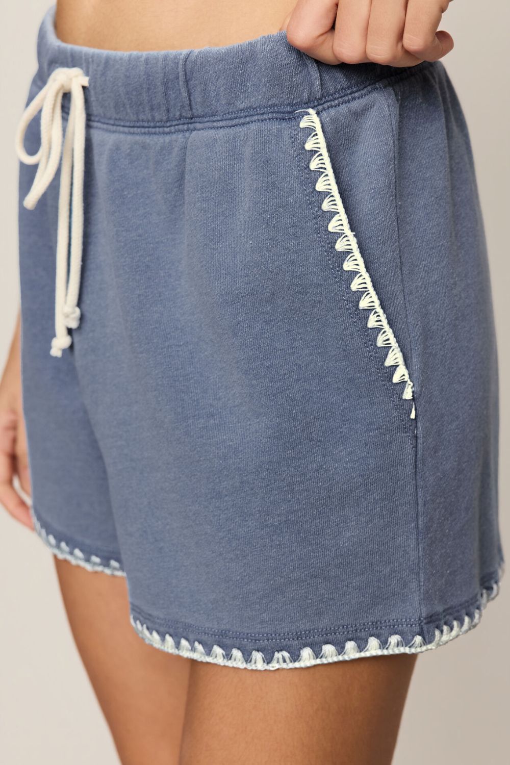 blue shorts with white details on a white background
