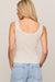 woman wearing a white tank top on a white background