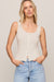 woman wearing a white tank top on a white background
