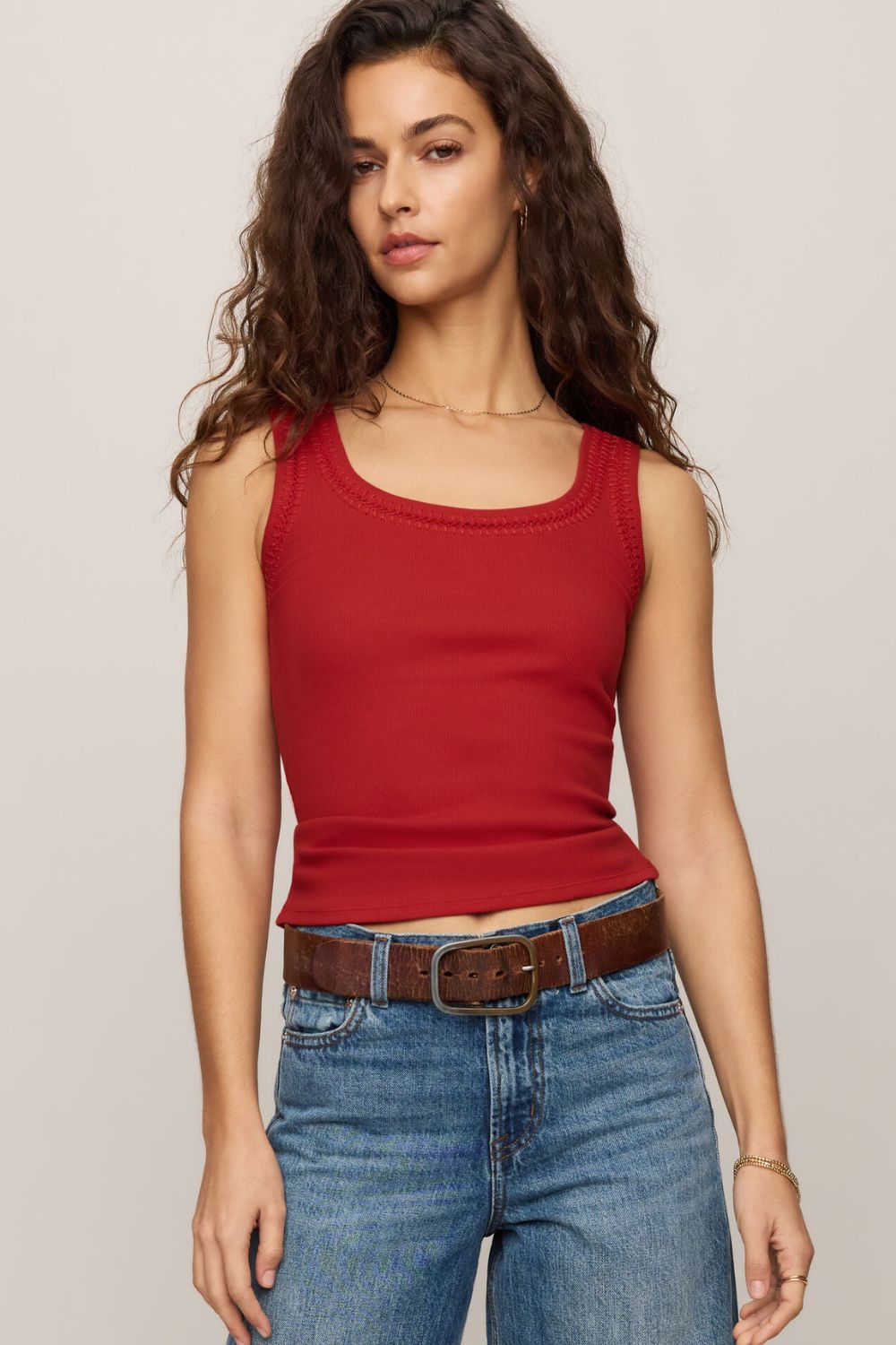 woman wearing a red tank top on a white background