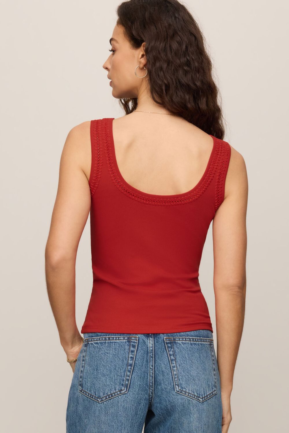 woman wearing a red tank top on a white background