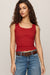 woman wearing a red tank top on a white background