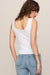 woman wearing white tank top on a white background