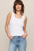 woman wearing white tank top on a white background