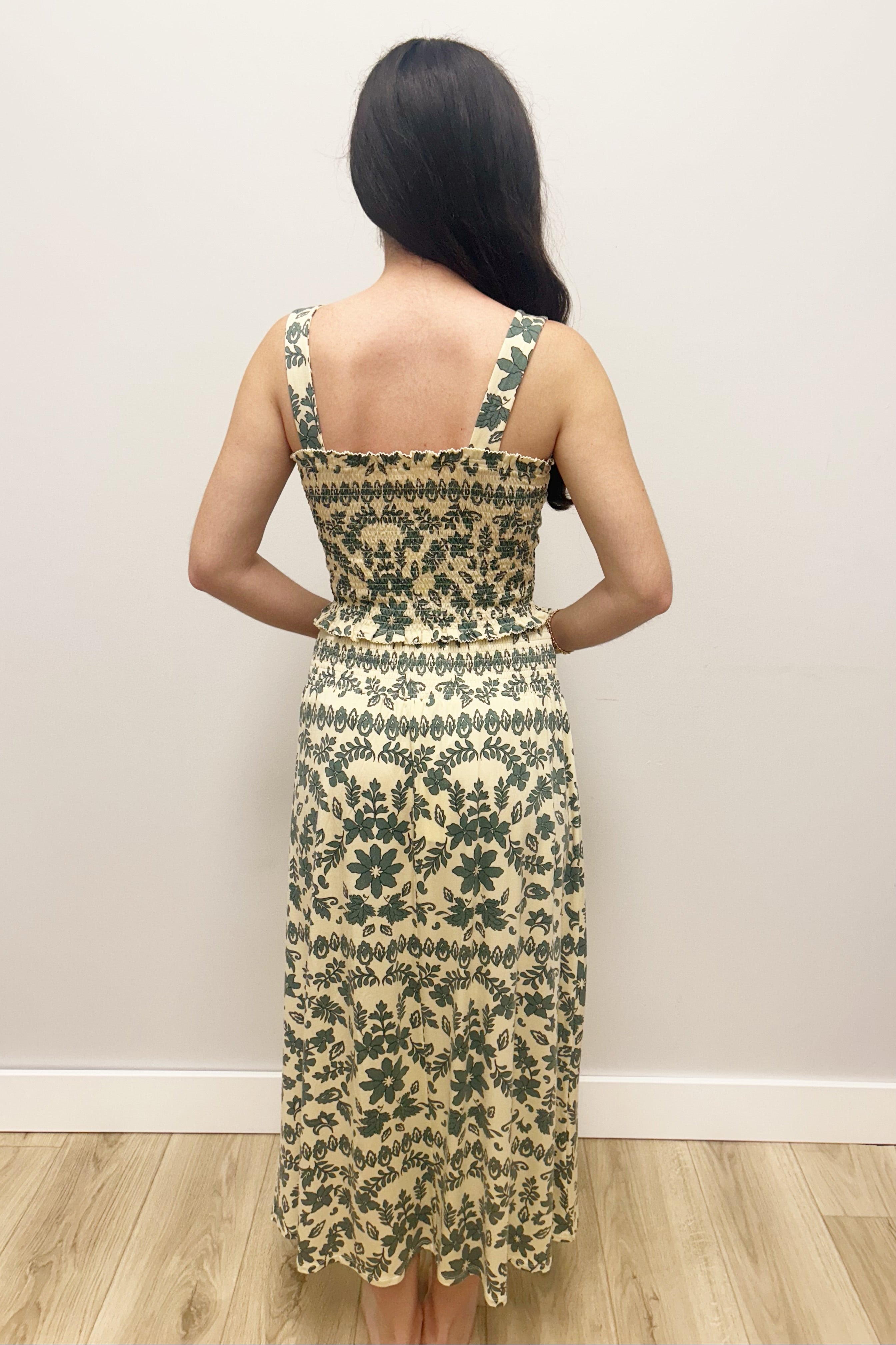 Woman wearing cream tank top with matching maxi skirt green floral detail