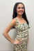 Woman wearing cream tank top with green floral detail