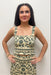 Woman wearing cream tank top with green floral detail