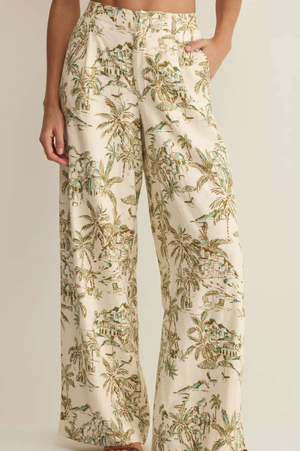 Tropical patterned pants worn by a person on a plain background