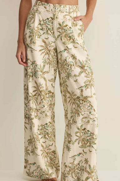 Tropical patterned pants worn by a person on a plain background