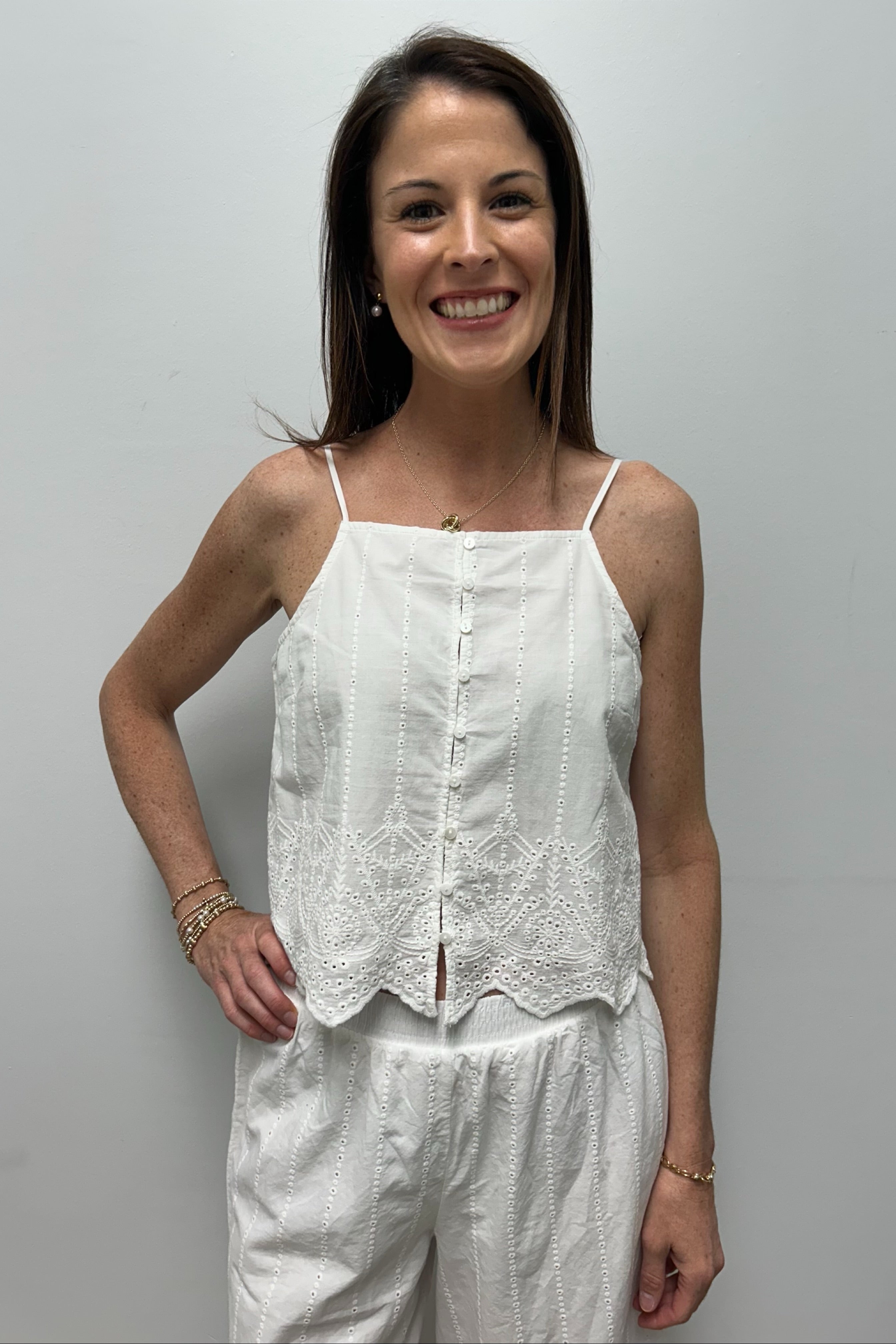 woman wearing white embroidered tank top
