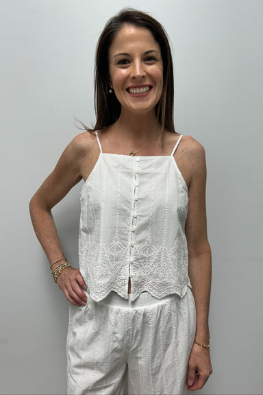 woman wearing white embroidered tank top