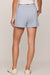 woman wearing blue shorts with a white background