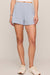 woman wearing blue shorts with a white background